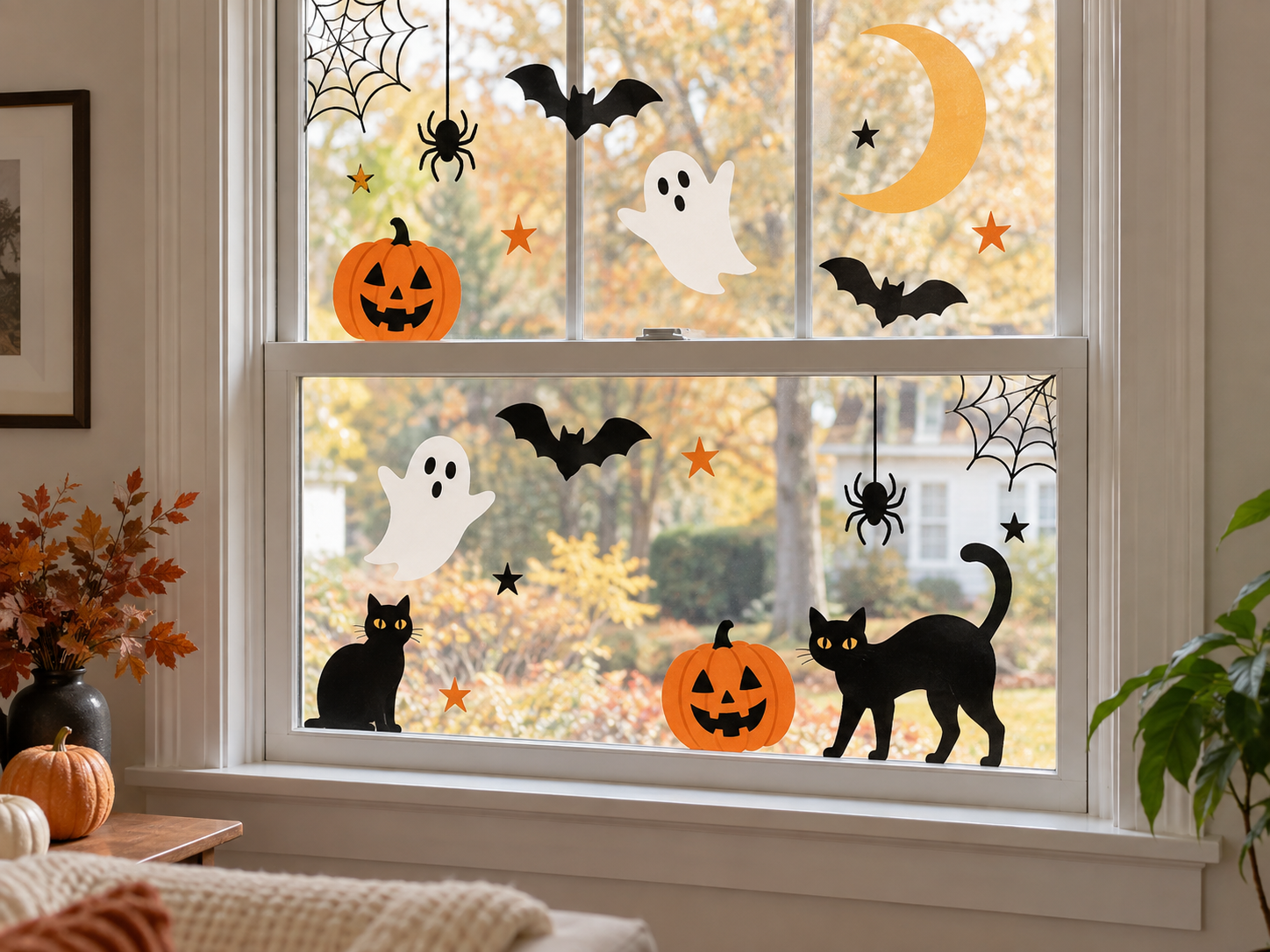 Reusable Halloween window clings with ghosts, bats, pumpkins, cats and spiders on a bright window